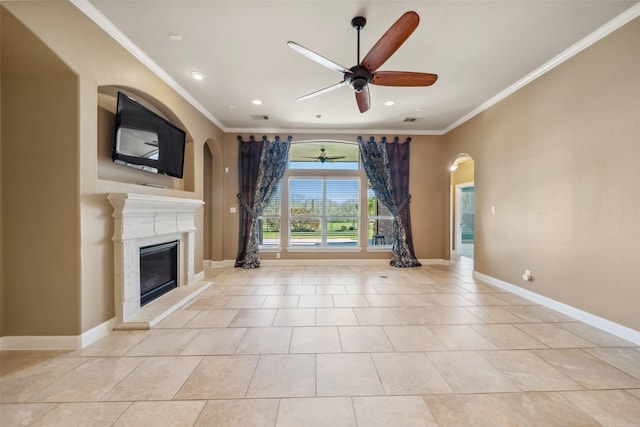 unfurnished living room featuring ornamental molding, a glass covered fireplace, and baseboards