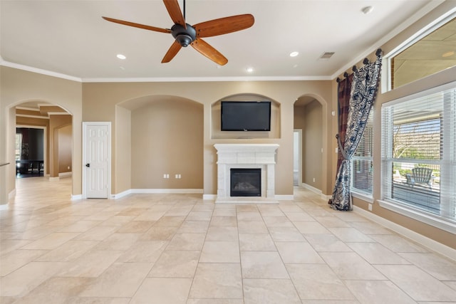 unfurnished living room with crown molding, recessed lighting, visible vents, a glass covered fireplace, and baseboards