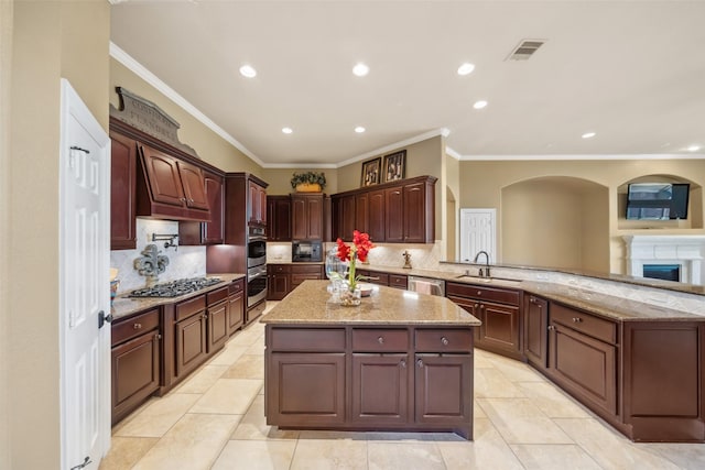 kitchen with tasteful backsplash, visible vents, appliances with stainless steel finishes, a sink, and a peninsula