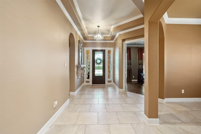 2405 Pebble Lodge Ln, Friendswood, TX 77546 - entrance foyer with arched walkways, crown molding, a chandelier, baseboards, and a tray ceiling