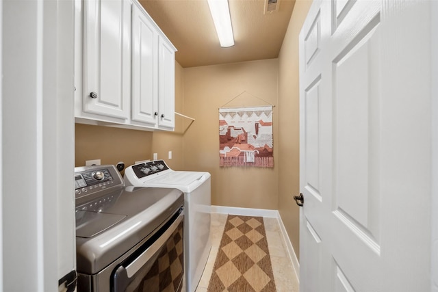 laundry room featuring visible vents, washer and clothes dryer, cabinet space, and baseboards