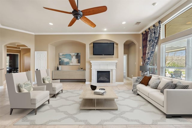 2405 Pebble Lodge Ln, Friendswood, TX 77546 - living area featuring arched walkways, crown molding, ceiling fan, baseboards, and recessed lighting