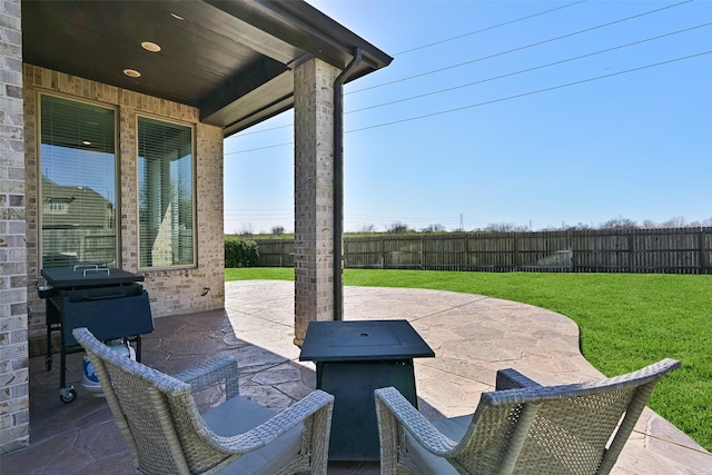 view of patio with a fenced backyard and a grill