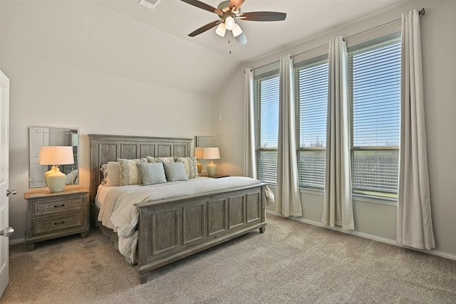 bedroom featuring light carpet, multiple windows, lofted ceiling, and baseboards