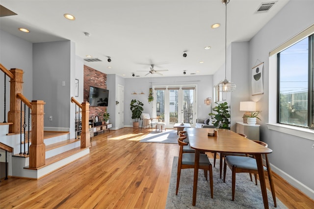 dining room featuring light wood finished floors, stairs, visible vents, and recessed lighting