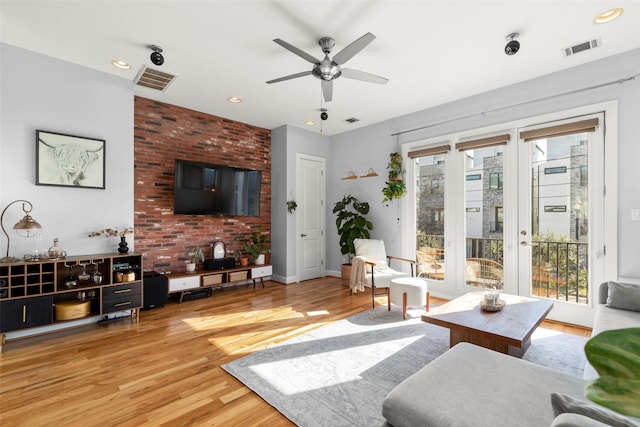 living room with visible vents, plenty of natural light, and wood finished floors