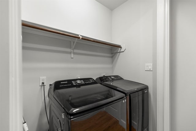 washroom with laundry area, separate washer and dryer, and wood finished floors