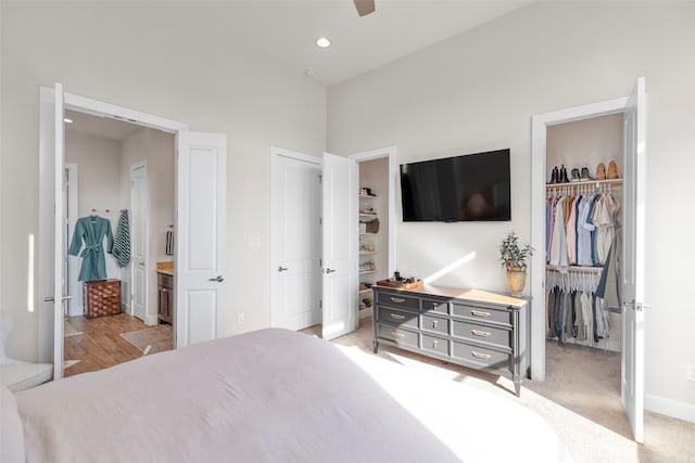 bedroom with a walk in closet, recessed lighting, a closet, ensuite bathroom, and ceiling fan