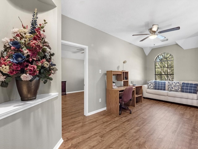 office with lofted ceiling, visible vents, a ceiling fan, wood finished floors, and baseboards