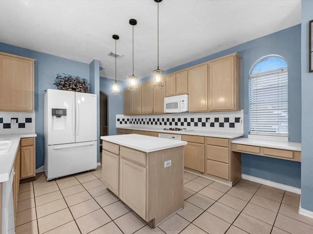 kitchen with white appliances, decorative backsplash, and light brown cabinetry