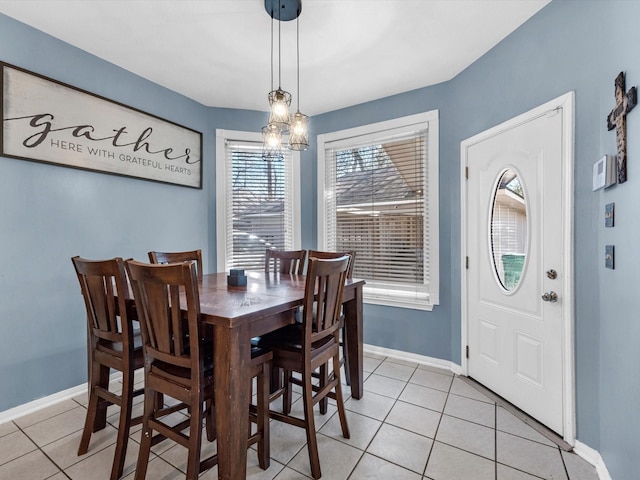 dining room with light tile patterned floors and baseboards