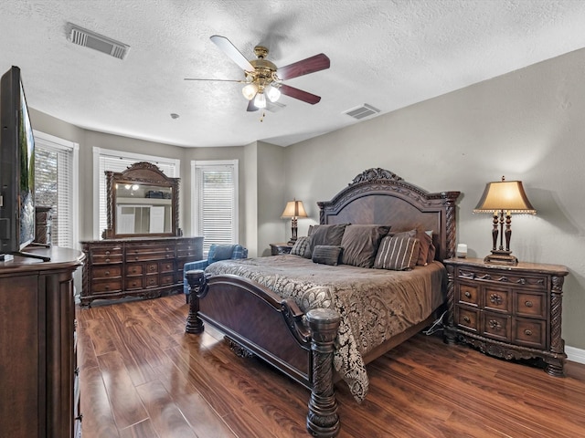 bedroom featuring multiple windows, visible vents, and wood finished floors