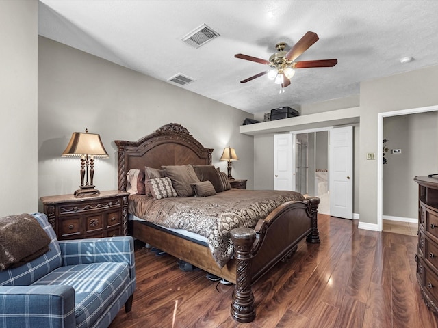 bedroom with wood finished floors, visible vents, and baseboards