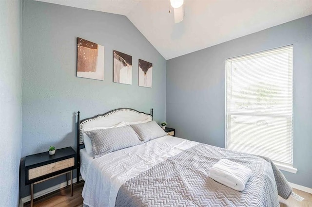 bedroom with lofted ceiling, ceiling fan, and baseboards