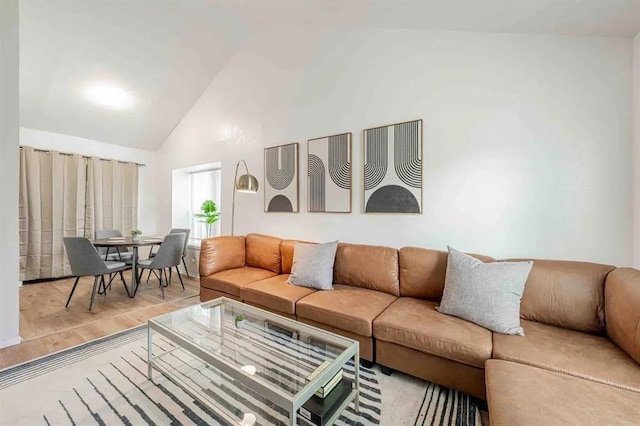 living room with high vaulted ceiling