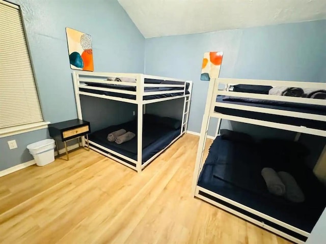 bedroom featuring wood finished floors and baseboards