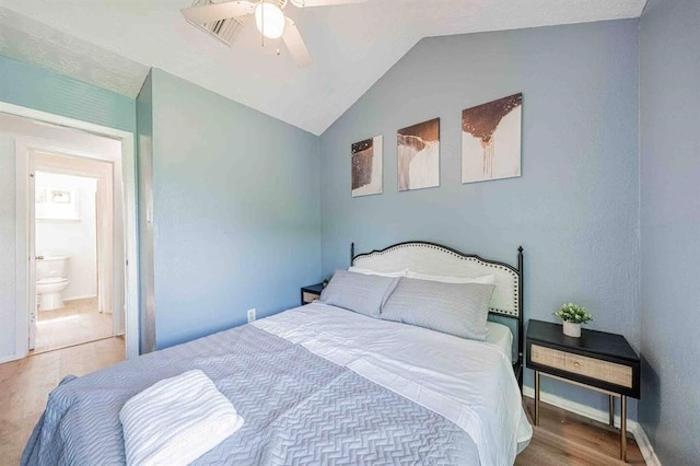 bedroom with a ceiling fan, vaulted ceiling, baseboards, and wood finished floors