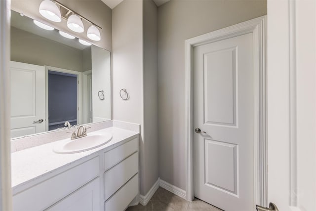 bathroom featuring tile patterned flooring, vanity, and baseboards