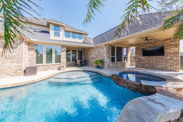 view of pool with ceiling fan, a patio, and a pool with connected hot tub