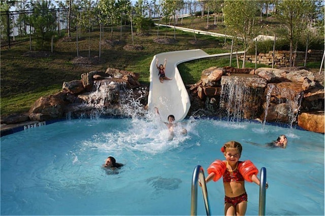 view of pool featuring fence