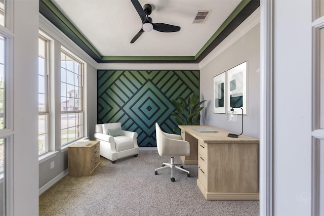 office area featuring visible vents, baseboards, an accent wall, ornamental molding, and carpet floors