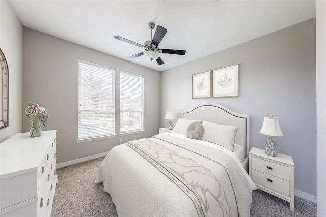 bedroom featuring baseboards, ceiling fan, and light colored carpet