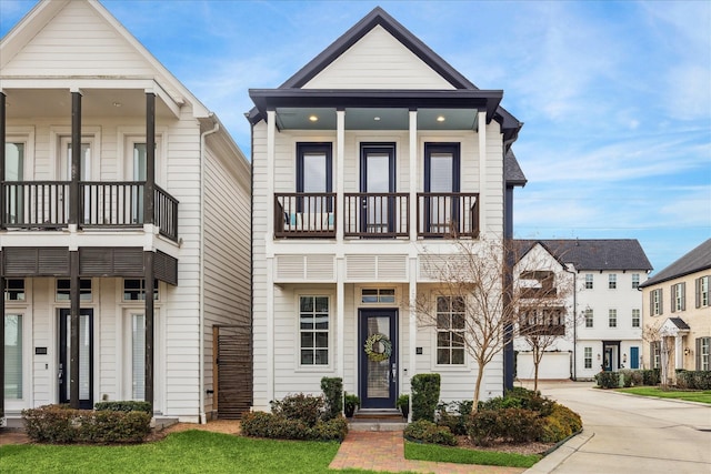 view of front of home featuring driveway and a balcony