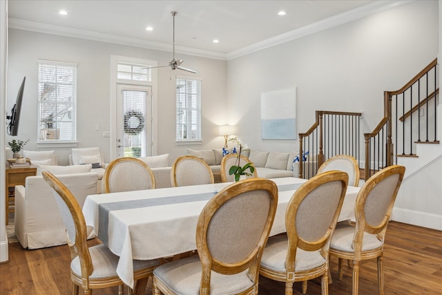 dining area featuring stairs, ornamental molding, and wood finished floors