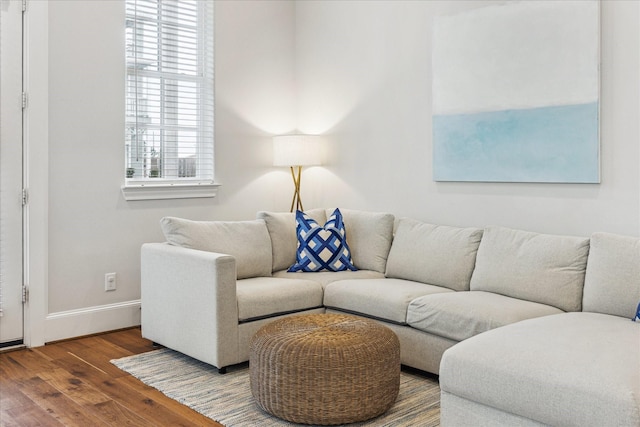 living area with wood finished floors and baseboards