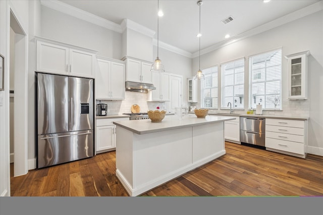 kitchen with visible vents, appliances with stainless steel finishes, glass insert cabinets, white cabinetry, and under cabinet range hood