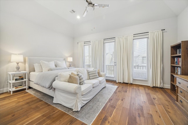 bedroom with lofted ceiling, recessed lighting, visible vents, baseboards, and hardwood / wood-style flooring