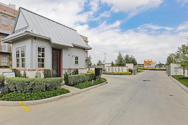 view of road featuring curbs and a gated entry