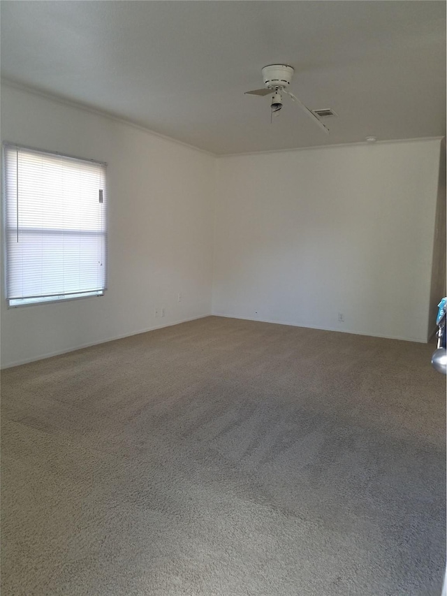 unfurnished room featuring a ceiling fan, visible vents, and carpet floors