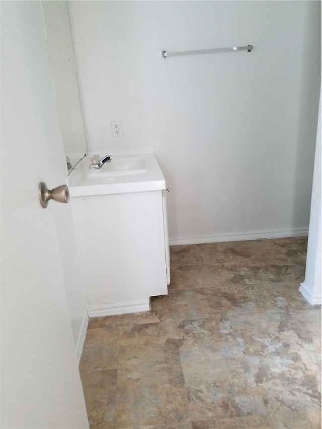 bathroom featuring vanity and baseboards