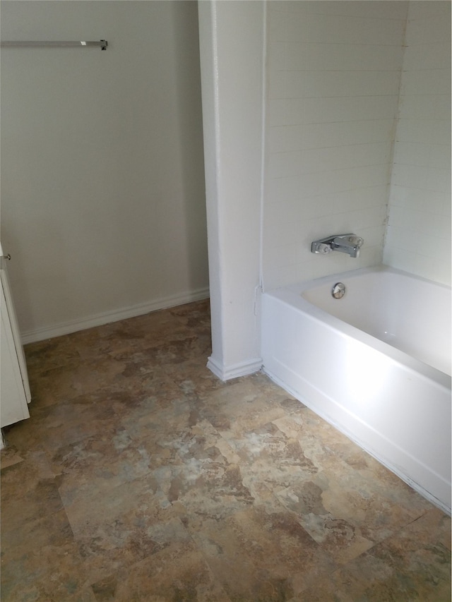 full bath with bathtub / shower combination and baseboards