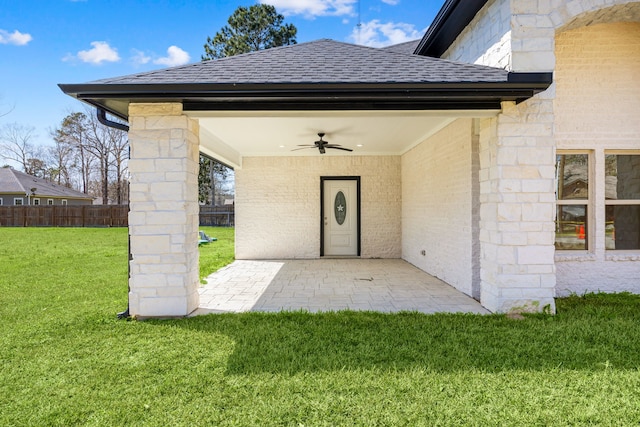 view of patio featuring fence and a ceiling fan