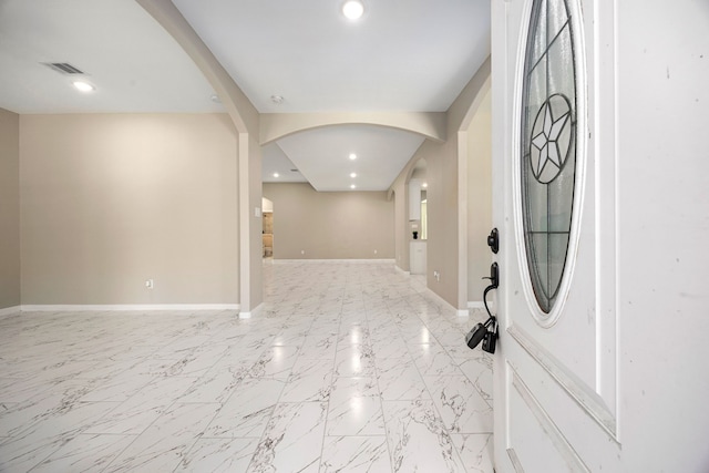 entrance foyer featuring arched walkways, recessed lighting, visible vents, and baseboards