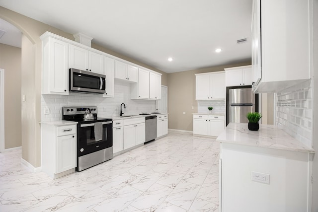 kitchen featuring marble finish floor, visible vents, appliances with stainless steel finishes, a sink, and baseboards