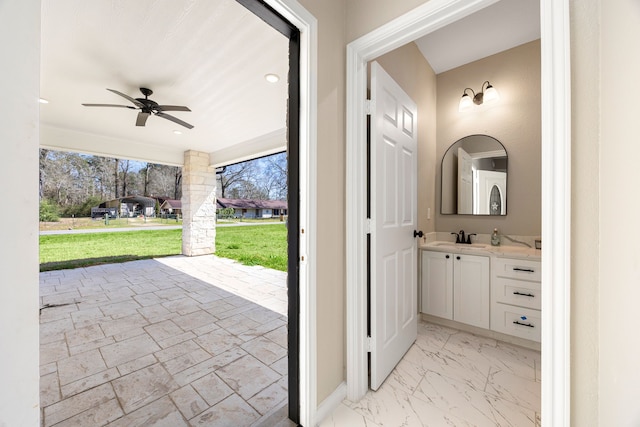 interior space featuring baseboards, a ceiling fan, marble finish floor, vanity, and recessed lighting