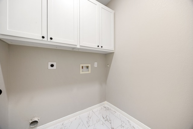 clothes washing area with cabinet space, baseboards, hookup for a washing machine, marble finish floor, and hookup for an electric dryer