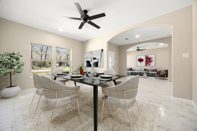 dining room with arched walkways, marble finish floor, recessed lighting, ceiling fan, and baseboards