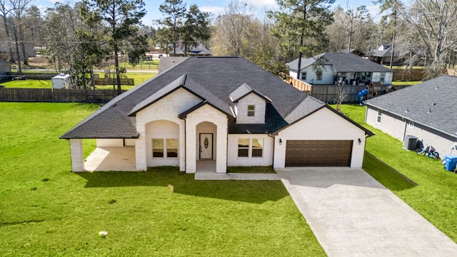 french country style house with a garage, driveway, a shingled roof, and a front yard