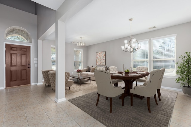 dining room with an inviting chandelier, baseboards, light tile patterned floors, and visible vents