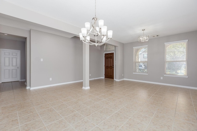 spare room featuring a chandelier, light tile patterned floors, visible vents, and baseboards