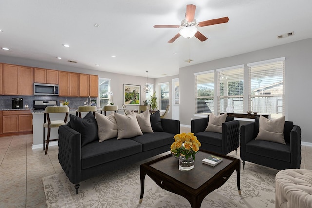 living room with light tile patterned floors, baseboards, visible vents, and recessed lighting