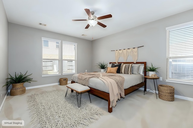 carpeted bedroom with baseboards, visible vents, and a ceiling fan