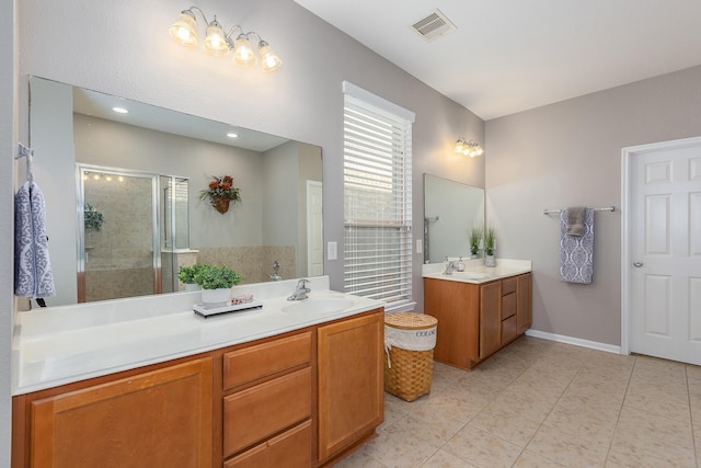 bathroom with visible vents, a shower stall, vanity, baseboards, and tile patterned floors