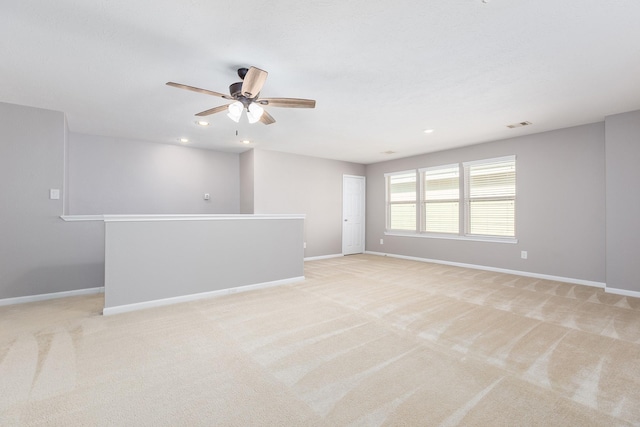 empty room with recessed lighting, baseboards, a ceiling fan, and light colored carpet