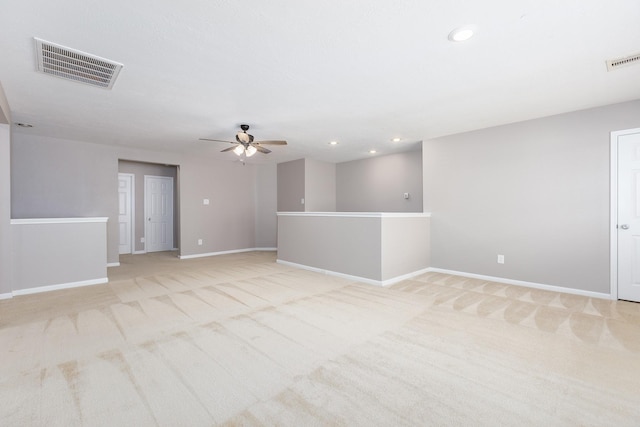 unfurnished room with recessed lighting, visible vents, light carpet, and baseboards