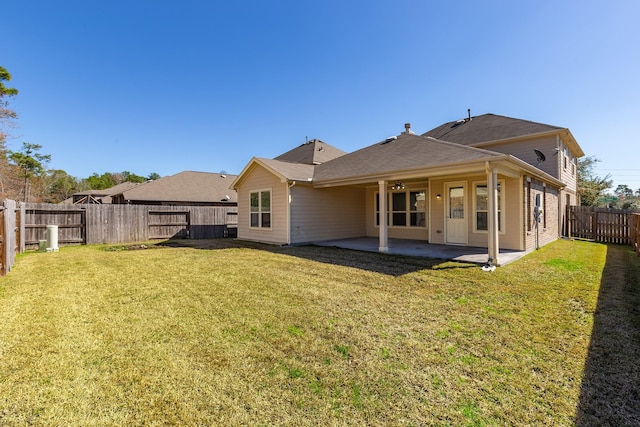 back of house with a patio area, a fenced backyard, and a yard